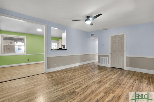 spare room with ceiling fan and hardwood / wood-style floors