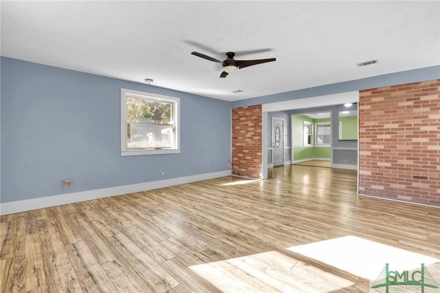 unfurnished living room featuring hardwood / wood-style flooring and ceiling fan