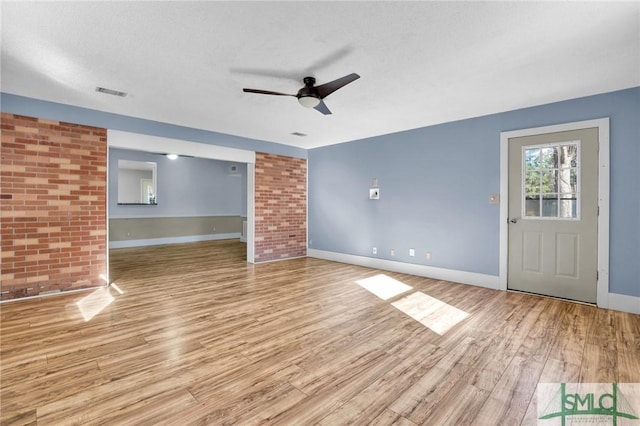 unfurnished living room with ceiling fan, light hardwood / wood-style flooring, and a textured ceiling