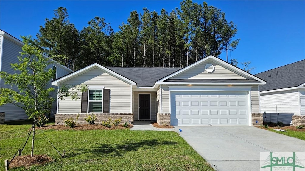 view of front of house with a garage and a front lawn