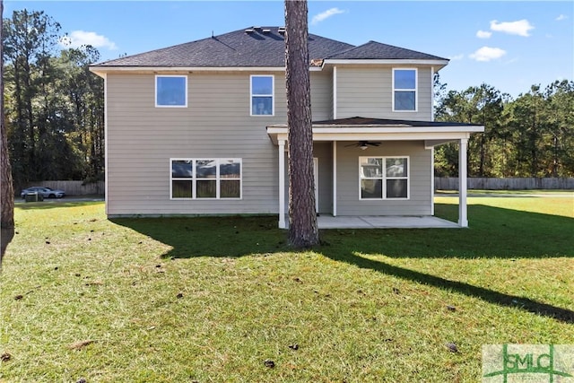 rear view of house featuring a lawn, ceiling fan, and a patio