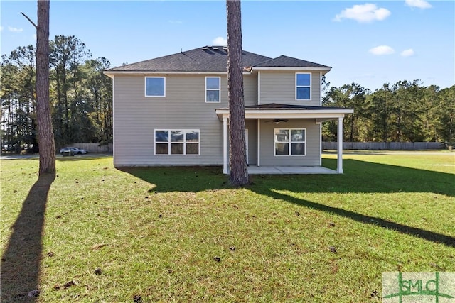 back of property with a patio area, ceiling fan, and a yard