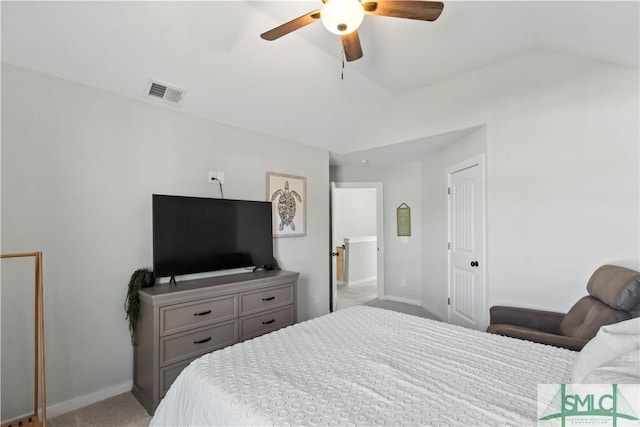 carpeted bedroom with ceiling fan and vaulted ceiling