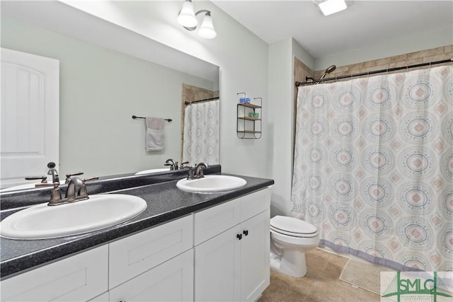 bathroom with tile patterned flooring, vanity, and toilet