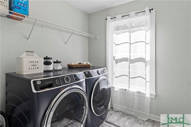 laundry area featuring washer and dryer and light wood-type flooring