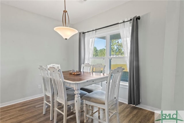 dining area featuring dark wood-type flooring