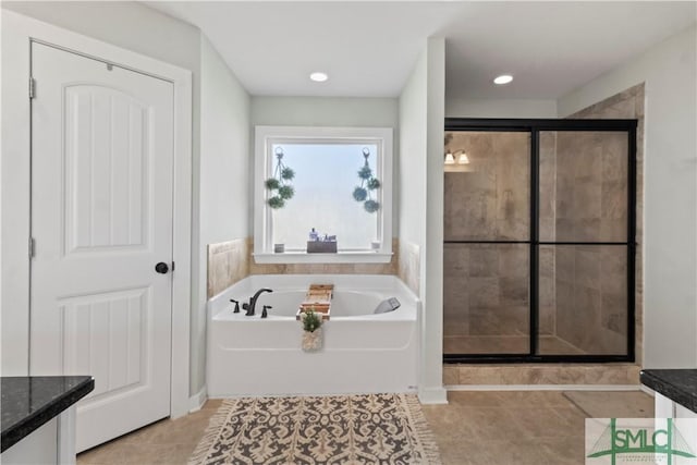 bathroom with tile patterned flooring, vanity, and independent shower and bath