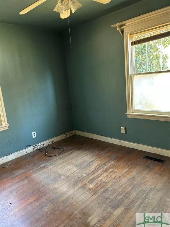 empty room featuring ceiling fan and hardwood / wood-style floors