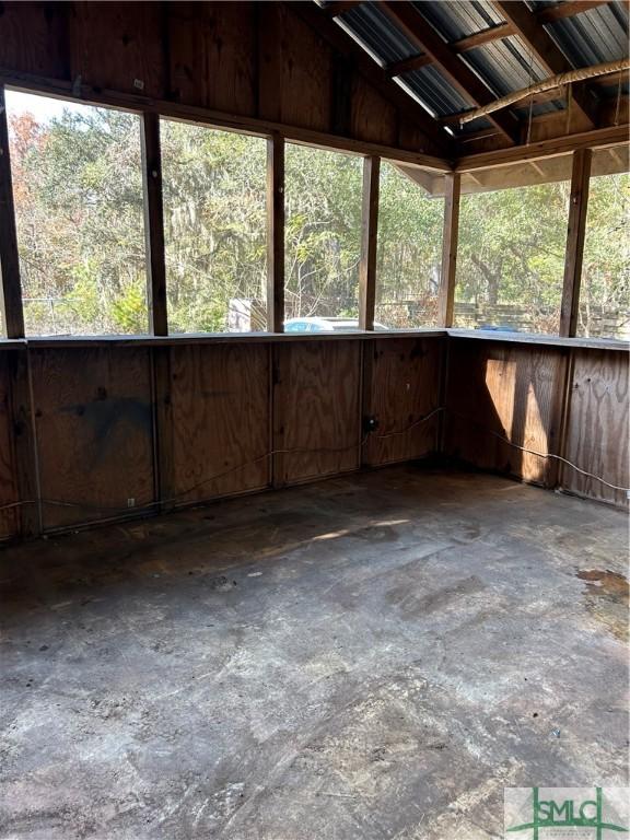 unfurnished sunroom featuring lofted ceiling