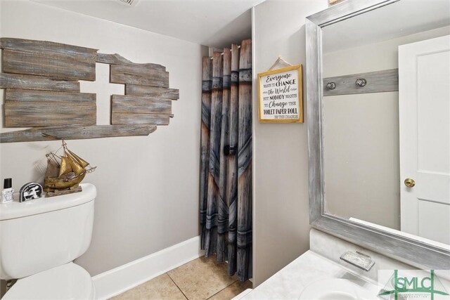 bathroom featuring tile patterned floors, vanity, and toilet