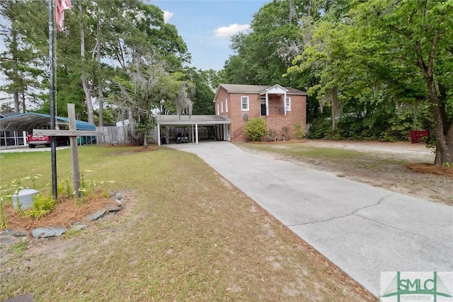 view of front of property featuring a front yard and a carport