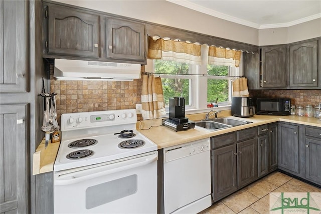 kitchen with sink, white appliances, light tile patterned floors, exhaust hood, and ornamental molding