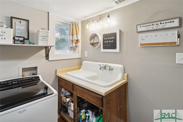 bathroom with washer / clothes dryer and sink