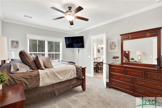 carpeted bedroom featuring ceiling fan, crown molding, and connected bathroom