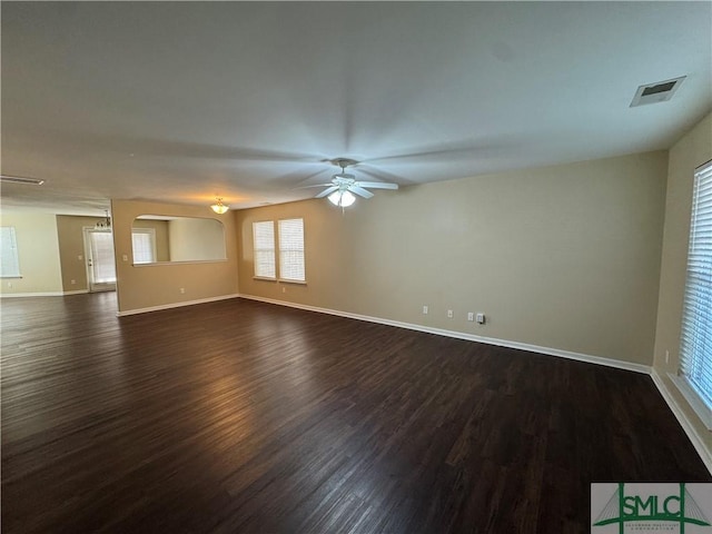 spare room featuring ceiling fan and dark wood-type flooring