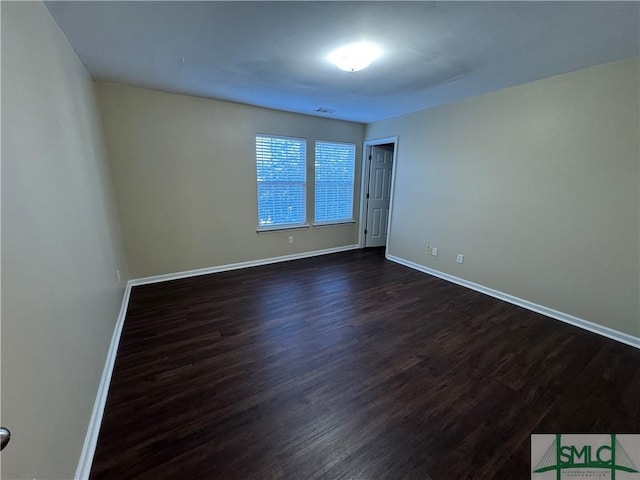 spare room featuring dark hardwood / wood-style flooring