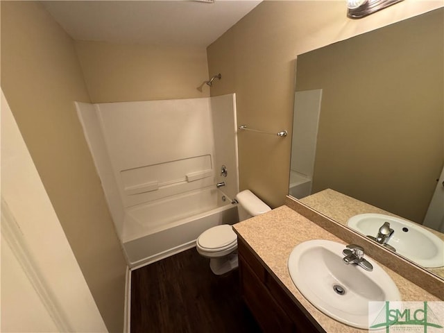 full bathroom with bathing tub / shower combination, hardwood / wood-style floors, vanity, and toilet