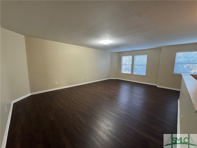 unfurnished room featuring dark hardwood / wood-style flooring