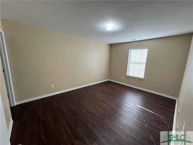 spare room with dark hardwood / wood-style floors