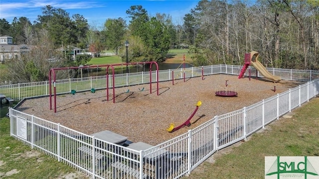 communal playground with fence and a lawn