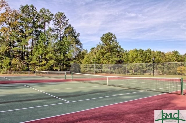 view of tennis court with fence