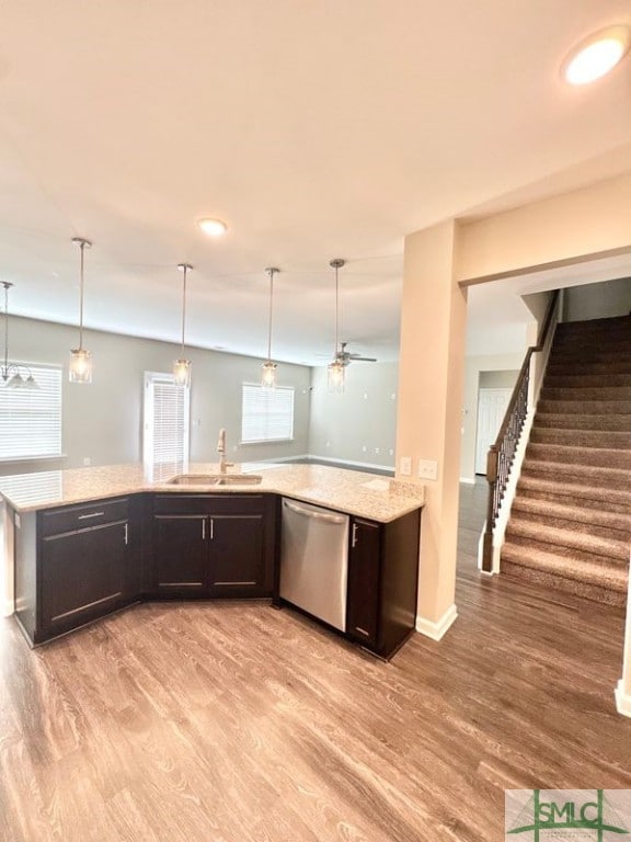 kitchen featuring a sink, light wood-type flooring, dishwasher, and dark brown cabinets