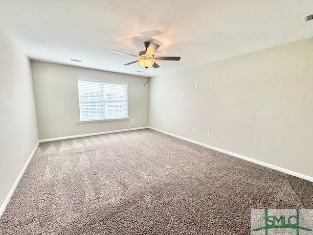 carpeted empty room with a ceiling fan, baseboards, and visible vents