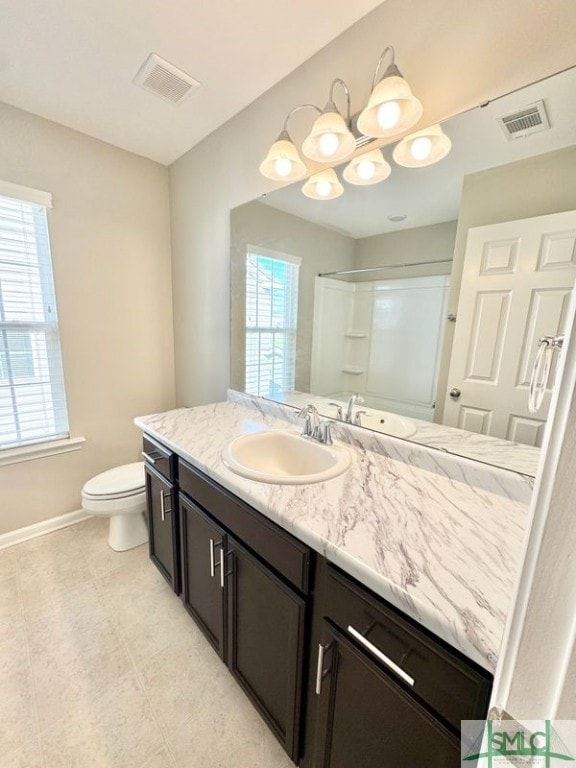 full bathroom featuring visible vents, toilet, vanity, and walk in shower