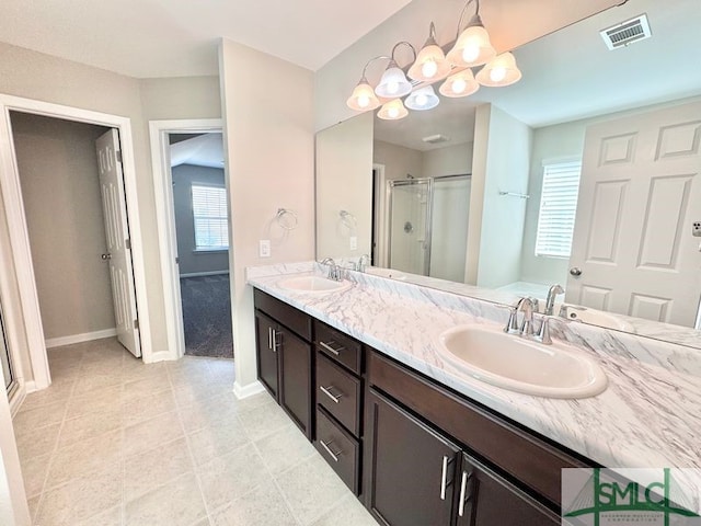 bathroom featuring a stall shower, visible vents, and a sink