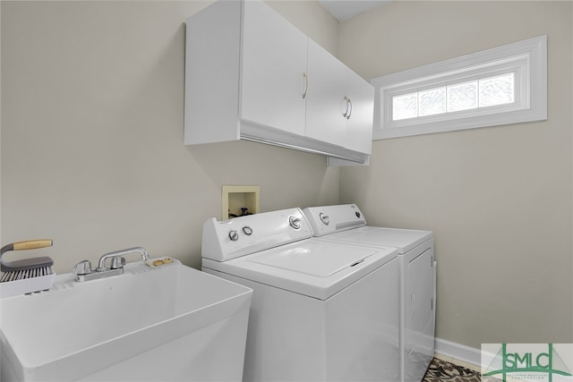 laundry room with washer and clothes dryer, cabinets, and sink