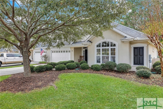 ranch-style home featuring a garage and a front lawn