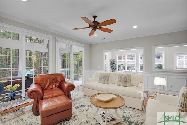 28 Turning Leaf Way, Savannah, GA 31419 - living area with a decorative wall, healthy amount of natural light, ornamental molding, ceiling fan, and wood finished floors