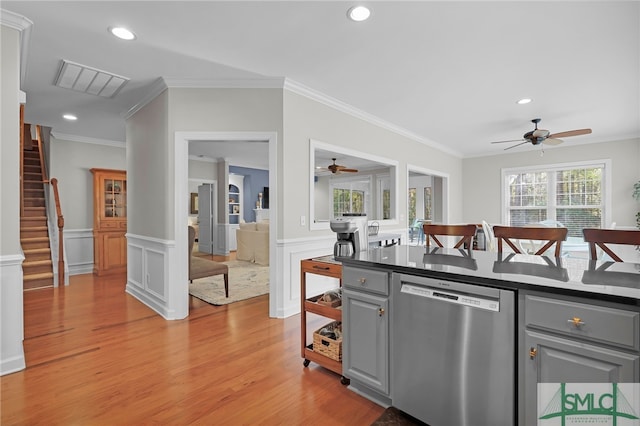 kitchen with gray cabinetry, crown molding, stainless steel dishwasher, and light hardwood / wood-style floors