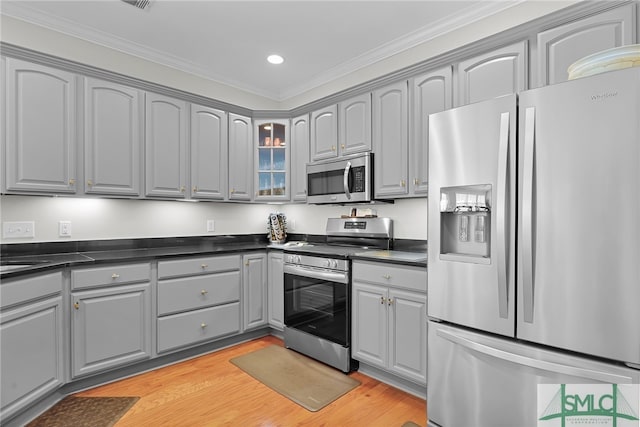 28 Turning Leaf Way, Savannah, GA 31419 - kitchen with stainless steel appliances, gray cabinetry, dark countertops, ornamental molding, and glass insert cabinets