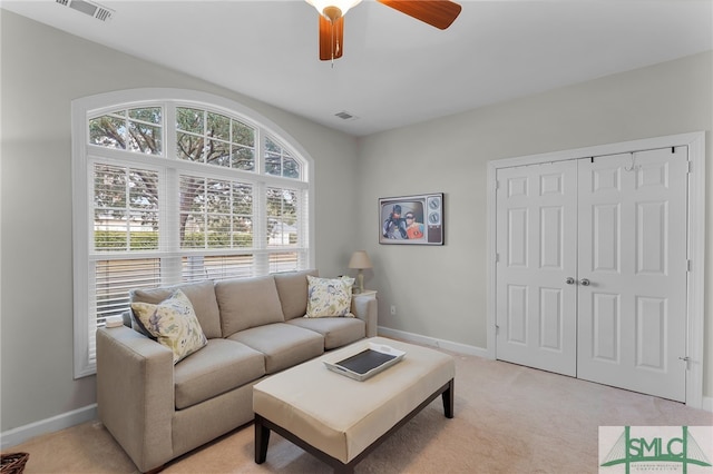 carpeted living room featuring ceiling fan