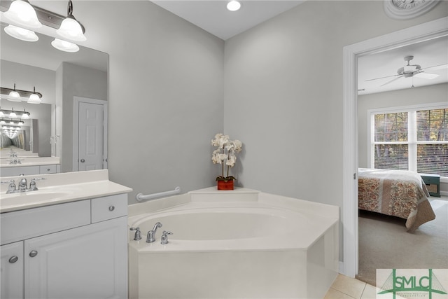 bathroom featuring a tub, ceiling fan, and vanity