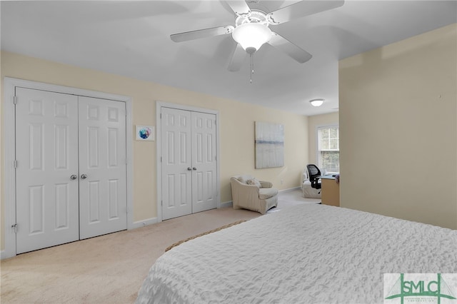 carpeted bedroom featuring two closets and ceiling fan