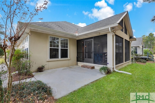 28 Turning Leaf Way, Savannah, GA 31419 - back of house with a sunroom, a patio area, a lawn, roof with shingles, and stucco siding