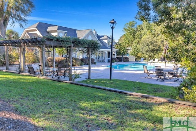 view of home's community featuring a lawn, a patio area, a pergola, and a swimming pool