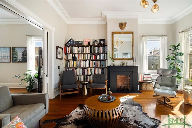 living area featuring ornamental molding and hardwood / wood-style flooring