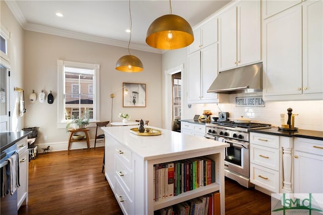 kitchen featuring white cabinets, hanging light fixtures, high end range, and tasteful backsplash