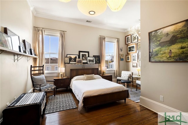 bedroom with dark hardwood / wood-style floors and crown molding