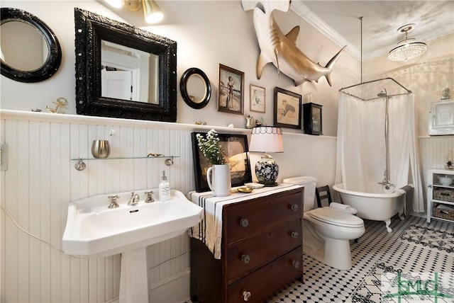 bathroom with toilet, ornamental molding, and shower / bathtub combination with curtain