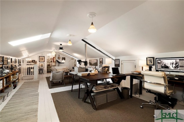 home office with vaulted ceiling and light hardwood / wood-style flooring