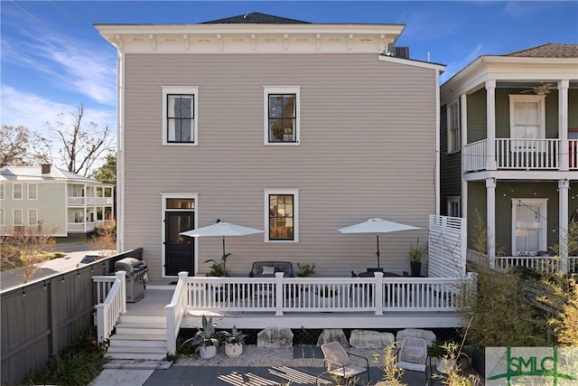 rear view of house with a wooden deck