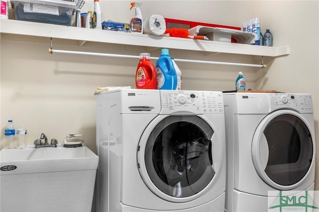 washroom featuring sink and washer and dryer