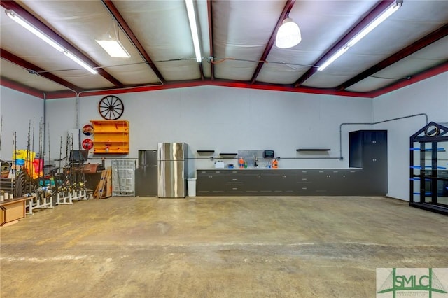 garage with stainless steel refrigerator