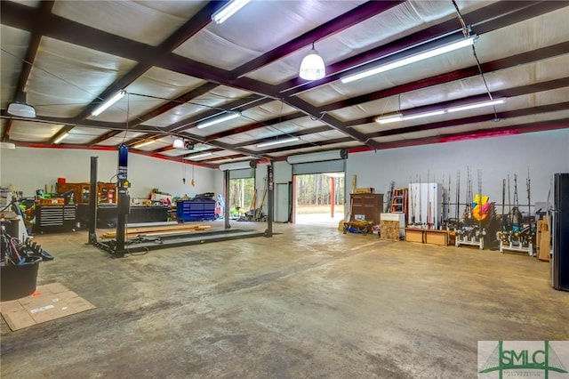 garage with stainless steel fridge and a garage door opener