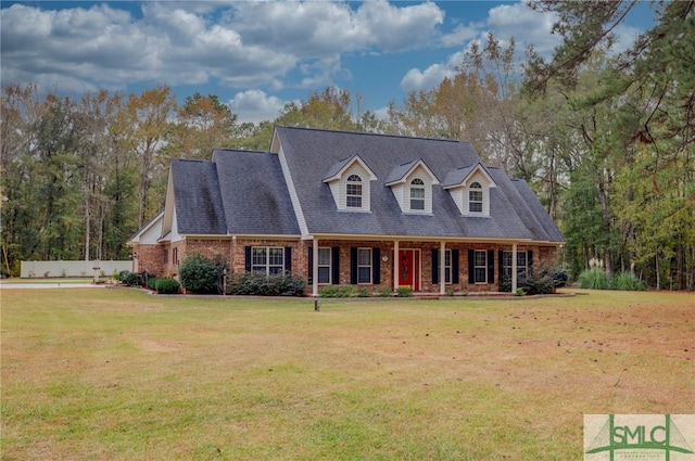 cape cod home featuring a front lawn