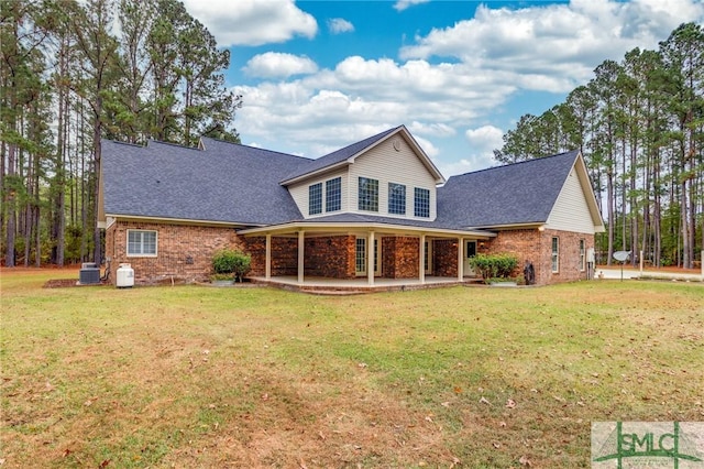 back of property featuring a lawn and cooling unit